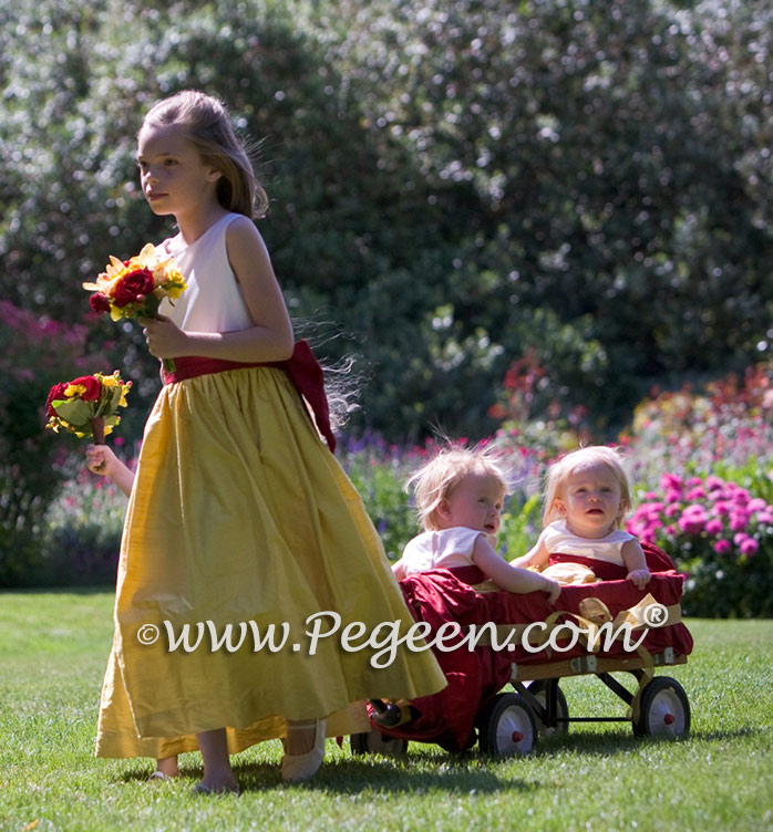 Mustard yellow and cranberry flower girl dress with babies in wagon